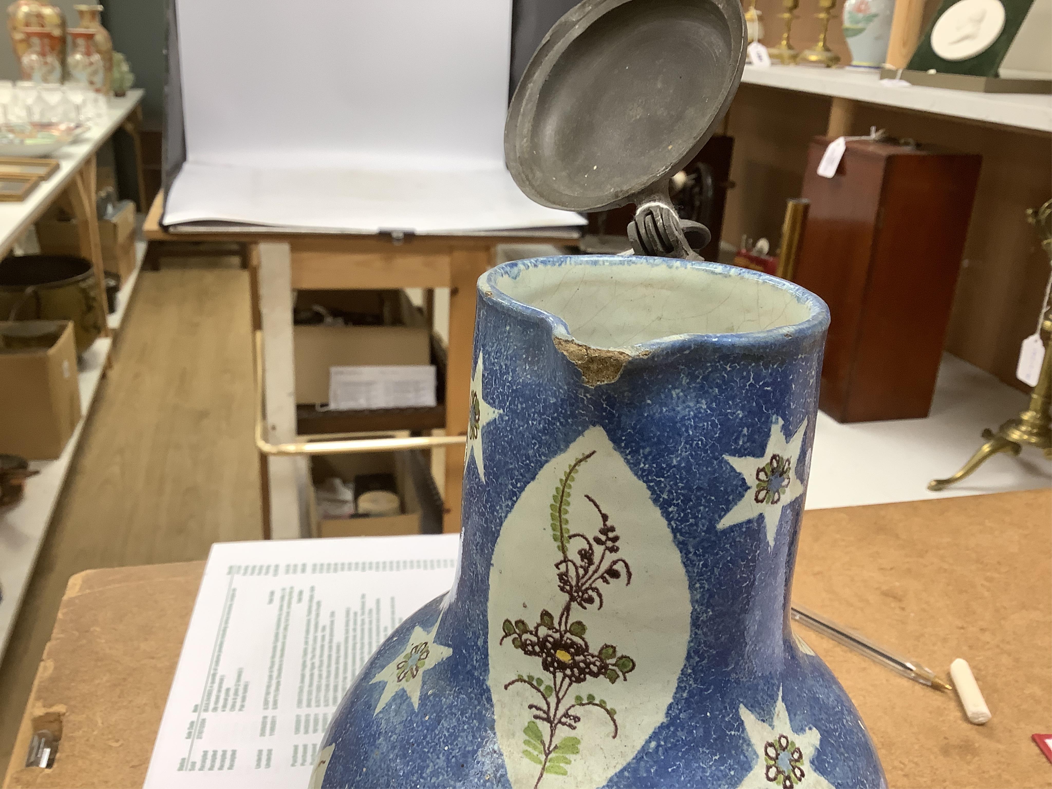 An 18th / 19th century Brussels faience jug and a French Quimper faience pottery jug, largest 25cm high. Condition - fair to good